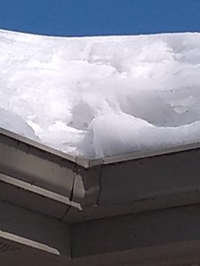 snow covered roof causing roof ice dams - ccs property services
